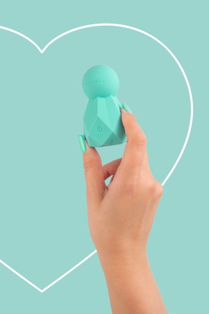 Fairygasm BlissKey vibrator in green held in hand, revealing curves and finishes